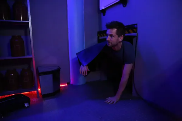 A player crawling through a hatch in the early Earthrise One room.