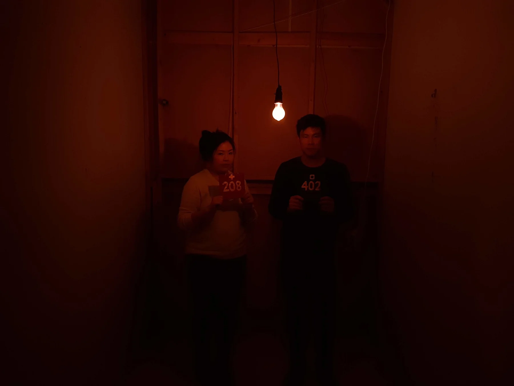 Players talking under amber lights in Gameshow.