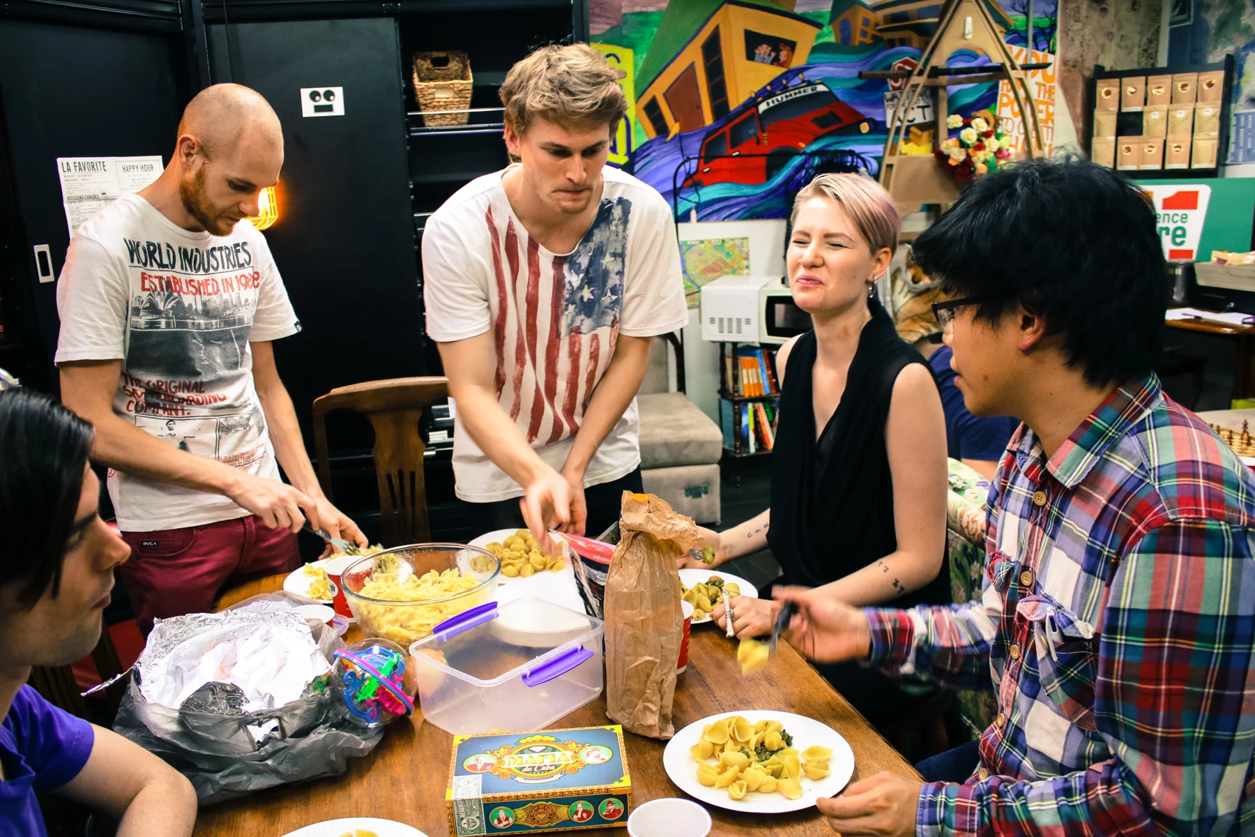 People gathered around a meal and a game.