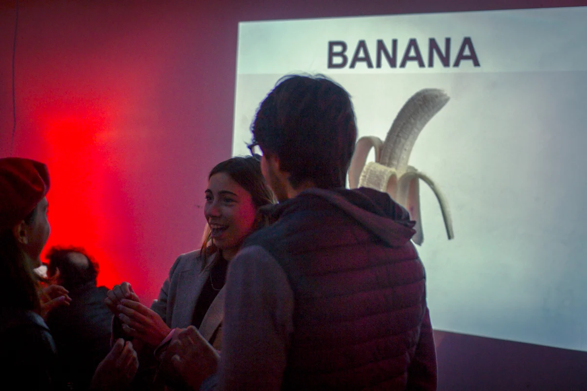 An Object Lesson player being guided in front of a projection of a banana.