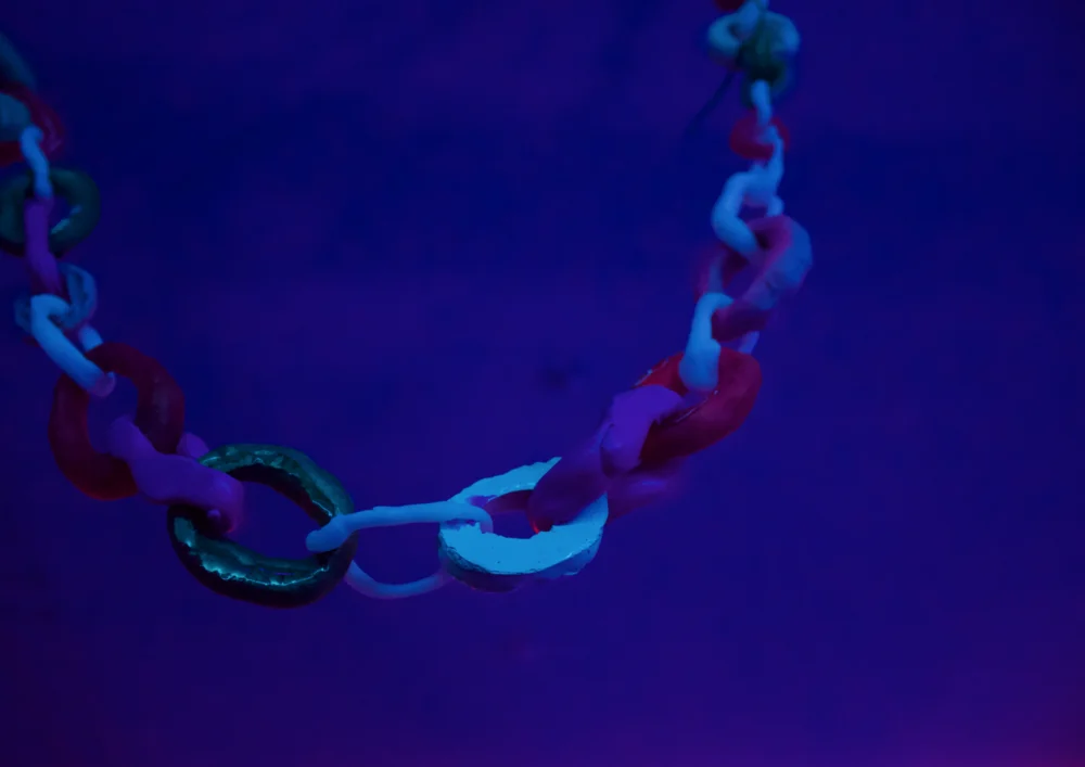 A string of objects lit in deep blue.