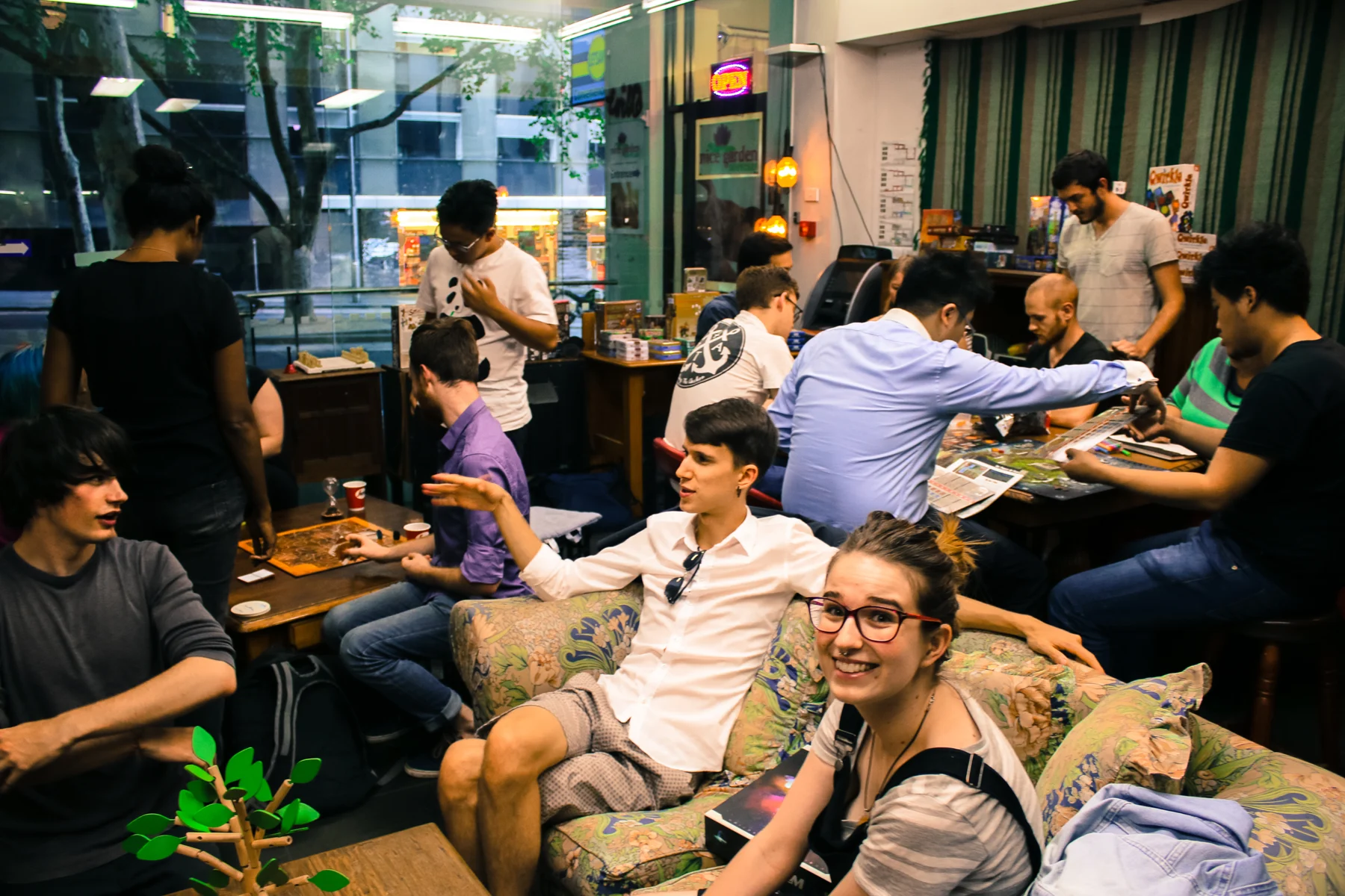 The busy communal tables of the Inconvenience Store.