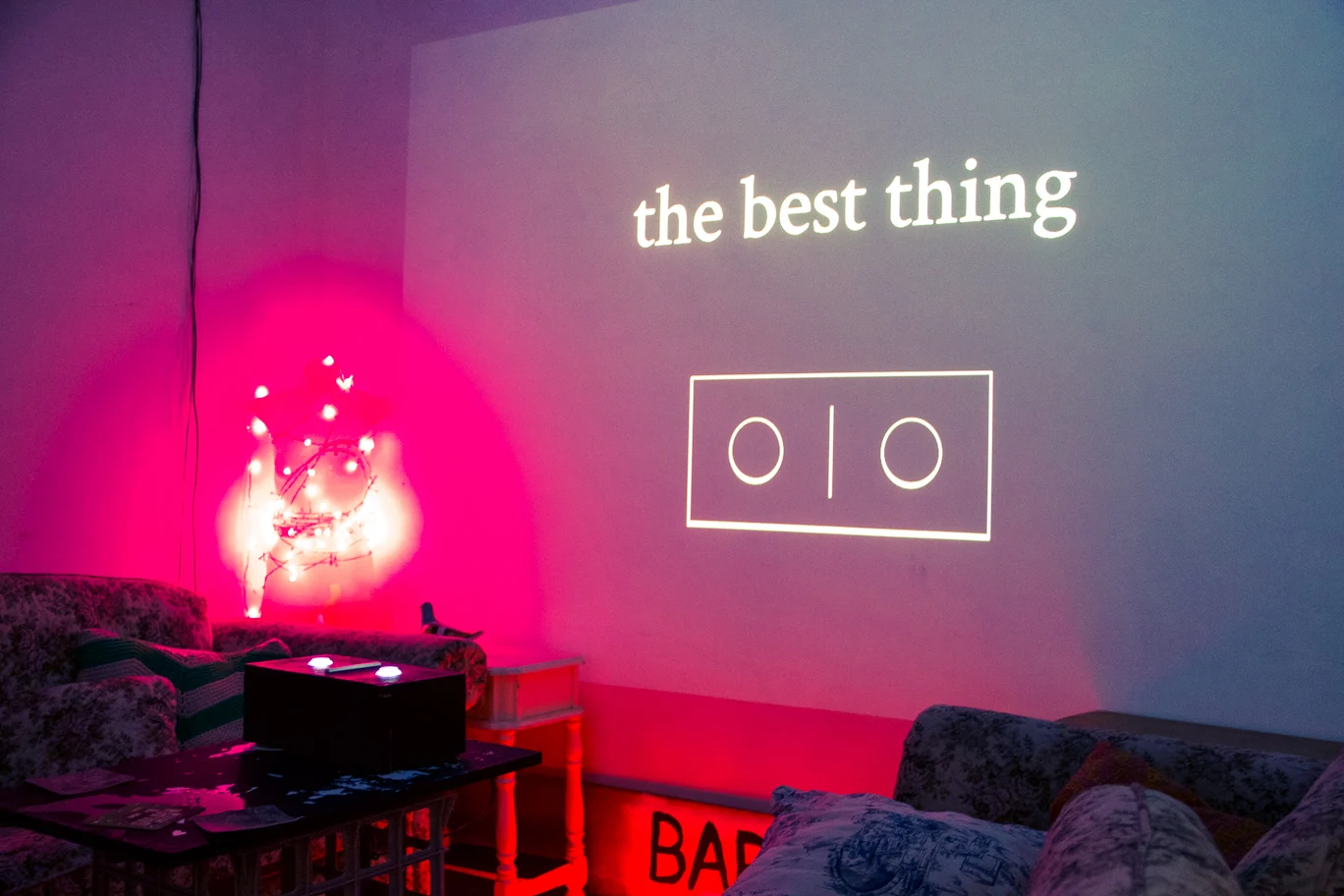 The Best Thing projected above two illuminated buttons at BAR SK.