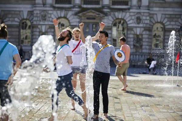 Players laughing between the fountains at Somerset House.