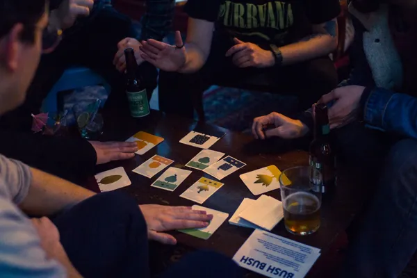 People playing Bush Bush around a table at BAR SK.